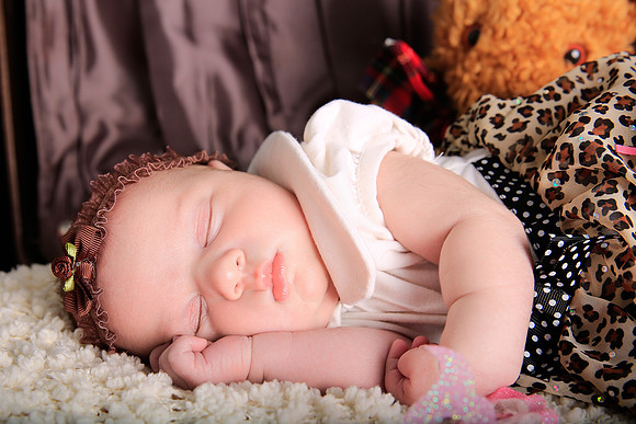 Portrait of newborn girl soundly sleeping