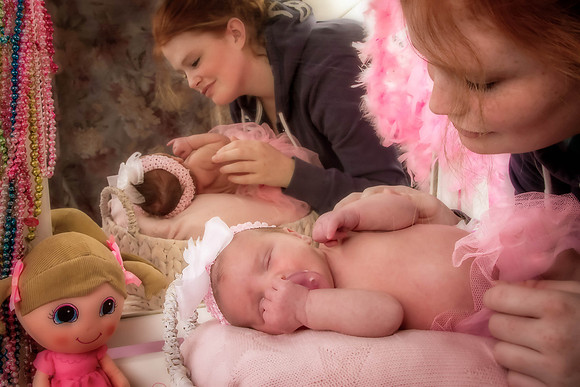 Portrait of mother soothing newborn girl
